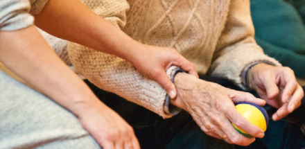 Picture of someone holding an elderly person's hand.