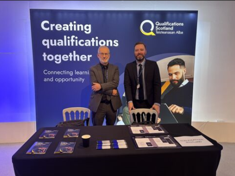Image of two men at a stand